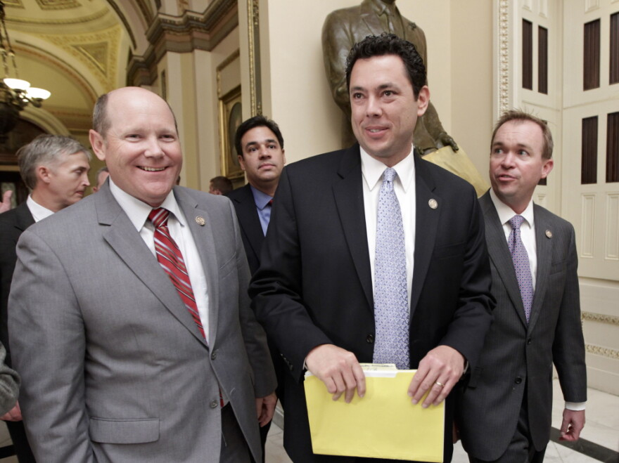 Rep. Reid Ribble, R-Wis., left, Rep. Jason Chaffetz, R-Utah, center, and other House Republicans, smile after the 234-190 passage of the conservative deficit reduction plan known as "Cut, Cap and Balance" in the GOP-controlled House, on Capitol Hill in Washington, Tuesday, July 19, 2011. Chaffetz, a member of the Budget Committee, was a sponsor of the legislation.