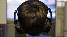 Henry Hailey, 10, plays Fortnite in the early morning hours in the basement of his Chicago home on Saturday, Oct. 6, 2018. His parents are on a quest to limit screen time for him and his brother. The boys say they understand sometimes, but also complain that they get less screen time than their friends. (Martha Irvine/AP)