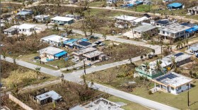 This photo provided by U.S. Marine Corps, debris covers homes and streets following Super Typhoon Sinlaku on the island of Saipan, April 18, 2026.