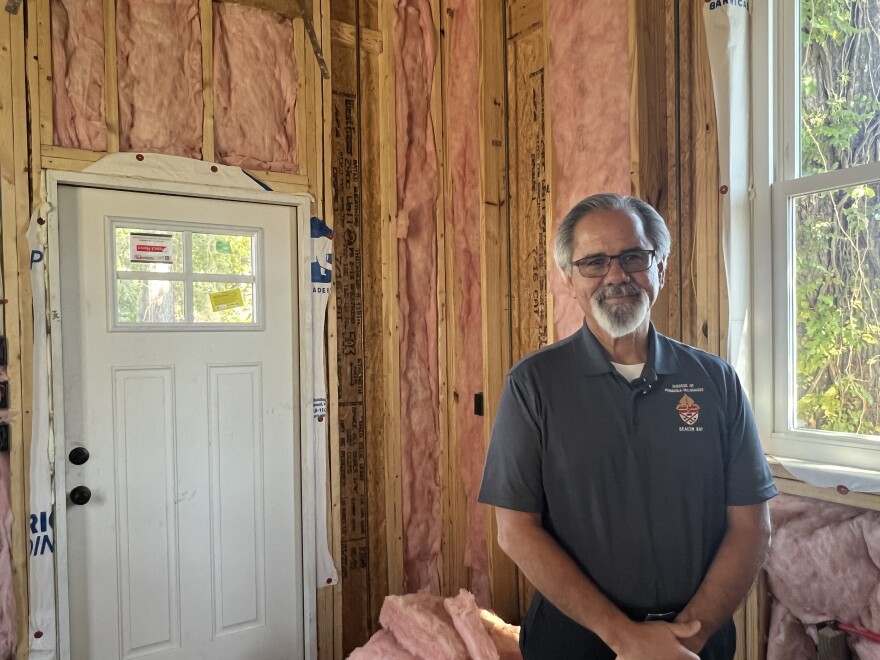 Deacon Ray Aquado stands inside one of the nine tiny homes at Pensacola's Trinity Village