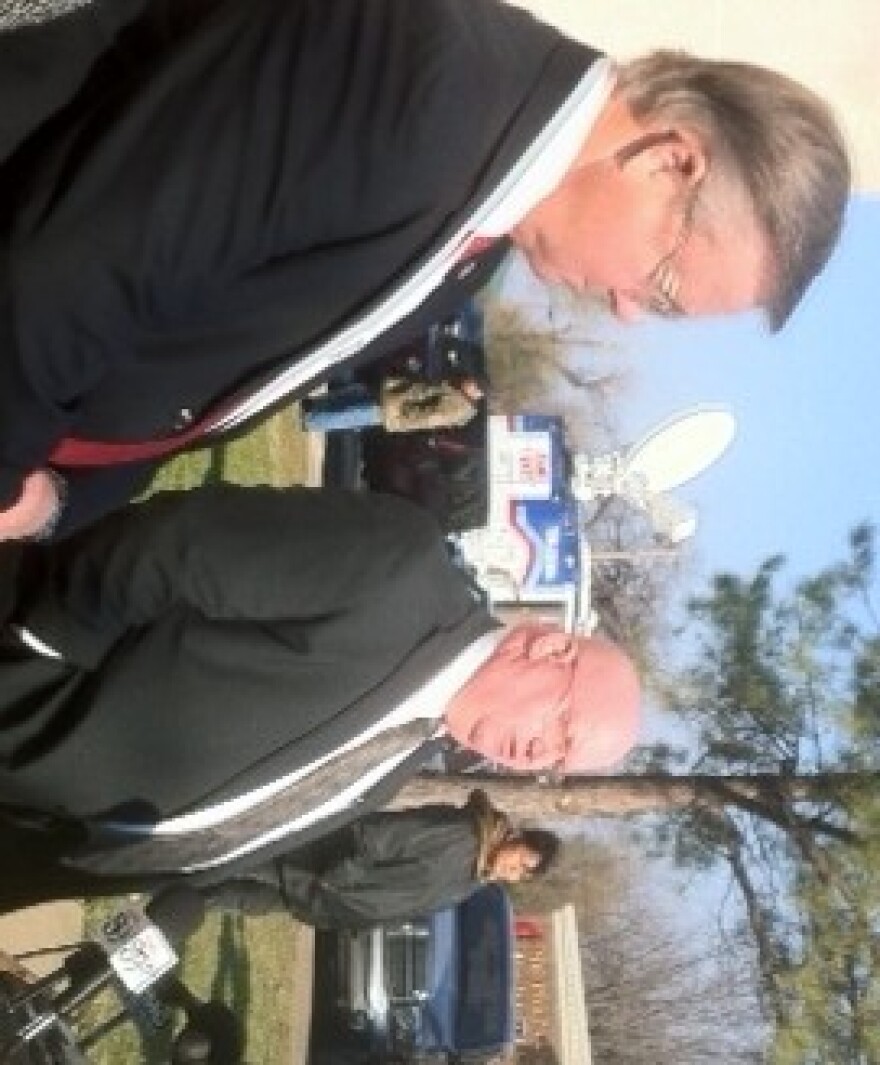 DA Max Cook listens as OSBI Director Stan Florence discusses case with reporters.