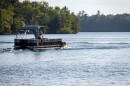 pontoon boat with canopy on lake