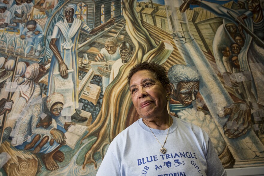 Charlotte Kelly Bryant, the Blue Triangle Multi-Cultural Association's founding president, stands in front of the John Biggers' 1953 mural, Contribution of Negro Women to American Life and Education, at the association's headquarters in Houston's Third Ward. The mural was damaged during Hurricane Harvey.