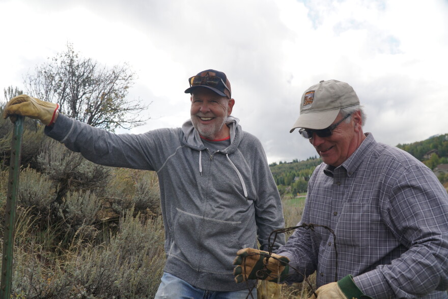 Volunteers remove barbed wire at the 910 Ranch.