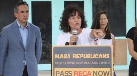 Tina Cordova, center, co-founder of the Tularosa Basin Downwinders Consortium, points to audience members who have been dealing with the consequences of radiation exposure, while politicians gathered for a news conference in Albuquerque, N.M., Tuesday, Aug. 13, 2024. (AP Photo/Susan Montoya Bryan)