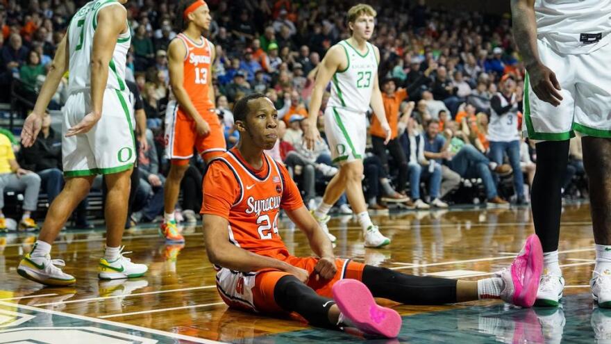 Quadir Copeland (24, orange) flexes his muscles on the Sanford Pentagon floor after a basket in SU's win over Oregon.