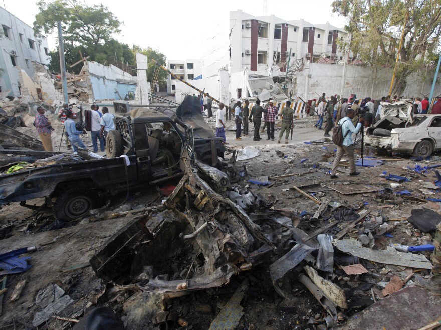 Rescue workers survey the devastation on Sunday after a vehicle bomb was detonated outside a hotel the night before.