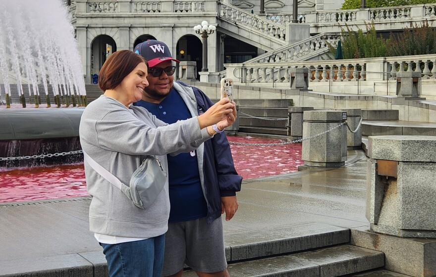 Ayden Thomas and his mom take a photo outside the Capitol.