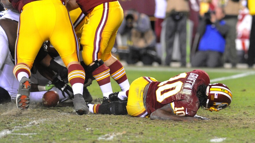 Redskins quarterback Robert Griffin III lays on the field after injuring his knee during an NFL playoff loss to the Seattle Seahawks on January 6. Griffin had knee surgery two days later.