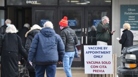 A photo shows Johnson County residents arriving at a vaccine clinic in Shawnee to receive COVID-19 shots.