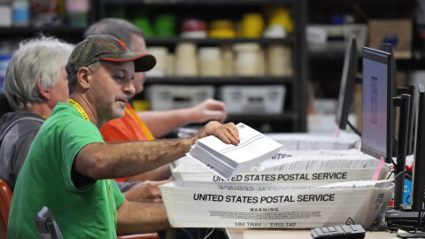 FILE - Allegheny County workers scan mail-in and absentee ballots at the Allegheny County Election Division Elections warehouse in Pittsburgh, Thursday, Nov. 3, 2022. A federal appeals court must decide if Pennsylvania voters who put the wrong date on the envelope containing their mail-in ballots should have their votes thrown out. The case argued Tuesday, Feb. 20, 2024, in Philadelphia could be significant in this year’s presidential contest.