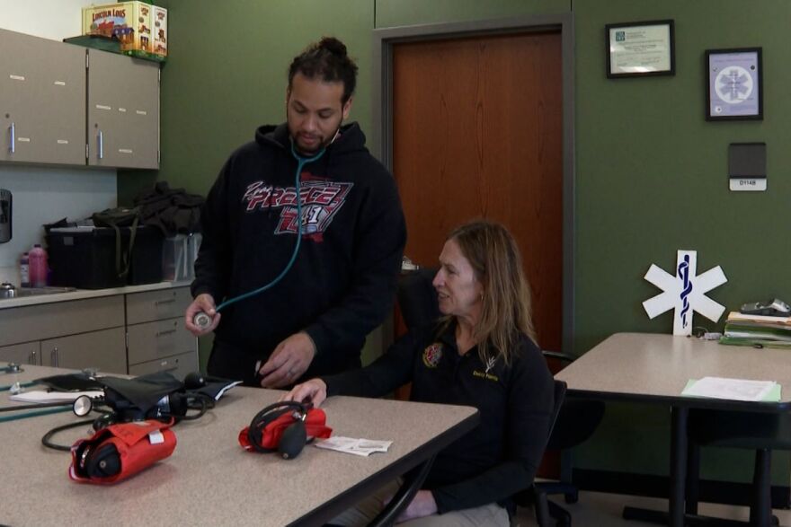 Student in Ivy Tech Bloomington's EMT course practices checking blood pressure with their instructor.