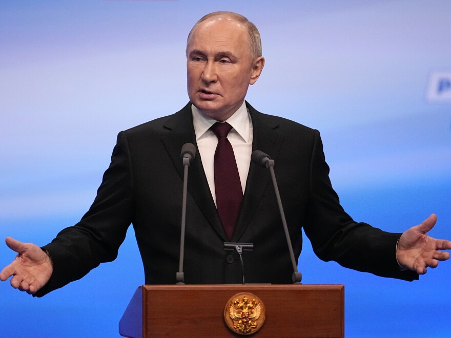 Russian President Vladimir Putin gestures while speaking on a visit to his campaign headquarters after a presidential election in Moscow, Russia, early Monday.
