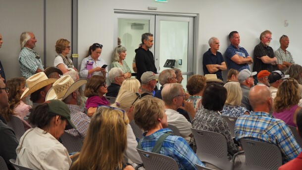 Summit County residents stand at an Aug. 6, 2026, Eastern Summit County Planning Commission hearing to see the slideshow presentation regarding Ivory Homes' potential development in Browns Canyon.