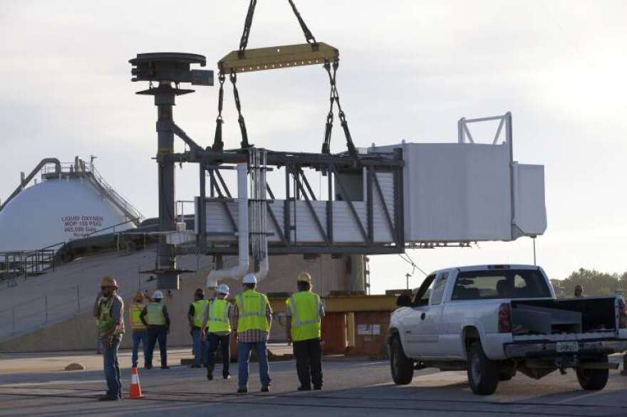 The 50-foot-long, 90,000-pound Crew Access Arm is hoisted off the ground to be installed on the Crew Access Tower at SLC-41.Photo: NASA/Kim Shiflett