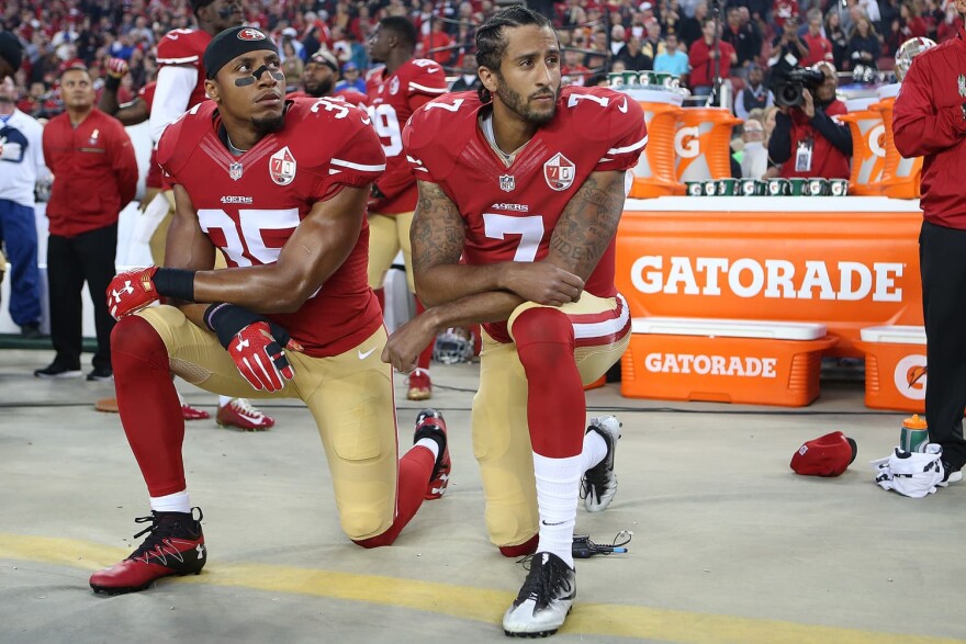 San Francisco 49ers Eric Reid and Colin Kaepernick kneel at a football game in 2016. (Daniel Gluskoter/AP)