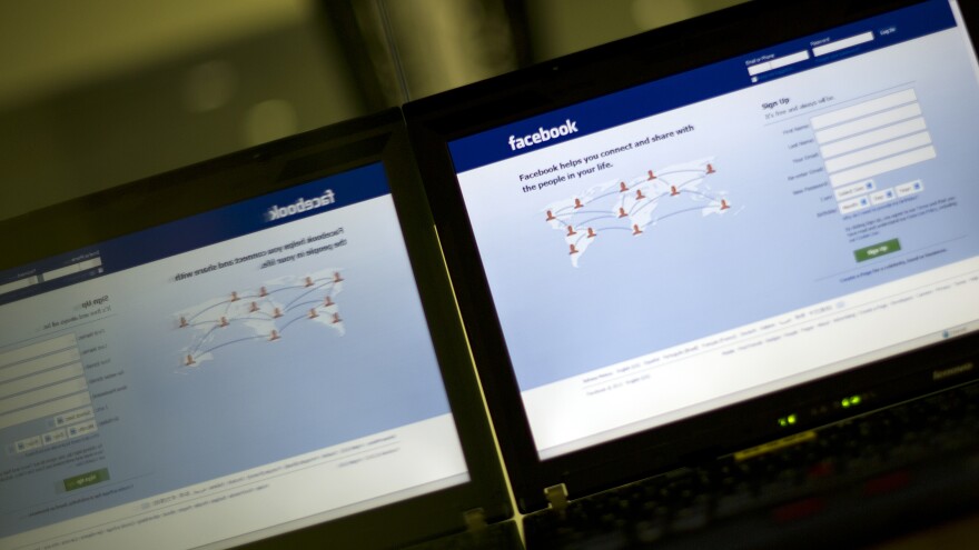 In a file photo taken on May 15, 2012, a login page of Facebook reflects in a glass panel in Kuala Lumpur.