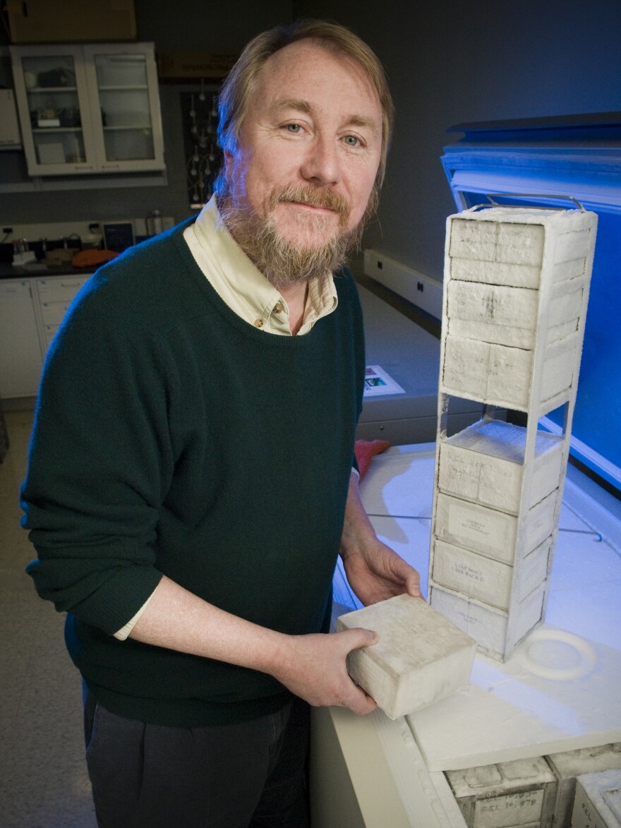 Michigan State's Richard Lenski pulls cultures of bacteria from a lab freezer.