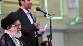 A handout picture released by the official website of Iran's Supreme Leader Ayatollah Ali Khamenei shows Khamenei listening to a speech by President Mahmoud Ahmadinejad (back) during a ceremony with other Iranian top officials and foreign ambassadors to mark the Muslim Eid al-Fitr feast in Tehran on Aug. 31, 2011.