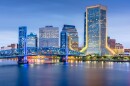 tall buildings and a bridge crossing a river 