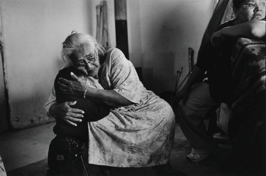 Lucy A. Willie comforts her granddaughter. Lucy’s daughter, Lucille, looks on. Three generations reside in this home, which is located within the boundaries of the proposed strip mine expansion.