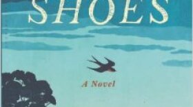 Drawing of small town set below large sky with one tree and one bird - primarily all in shades of blue