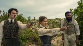 Enola Holmes 3. (L to R) Louis Partridge as Tewkesbury, Millie Bobby Brown as Enola Holmes and Himesh Patel as Dr. Watson in Enola Holmes 3. Cr. John Wilson/Netflix ©2026