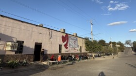 People in need in Hermosillo eat dinner outside the Vida Plena Corazón Contento soup kitchen. This nonprofit also doubles as a migrant shelter.