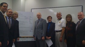 Tulsa County's elected leaders surround their A+ report card.