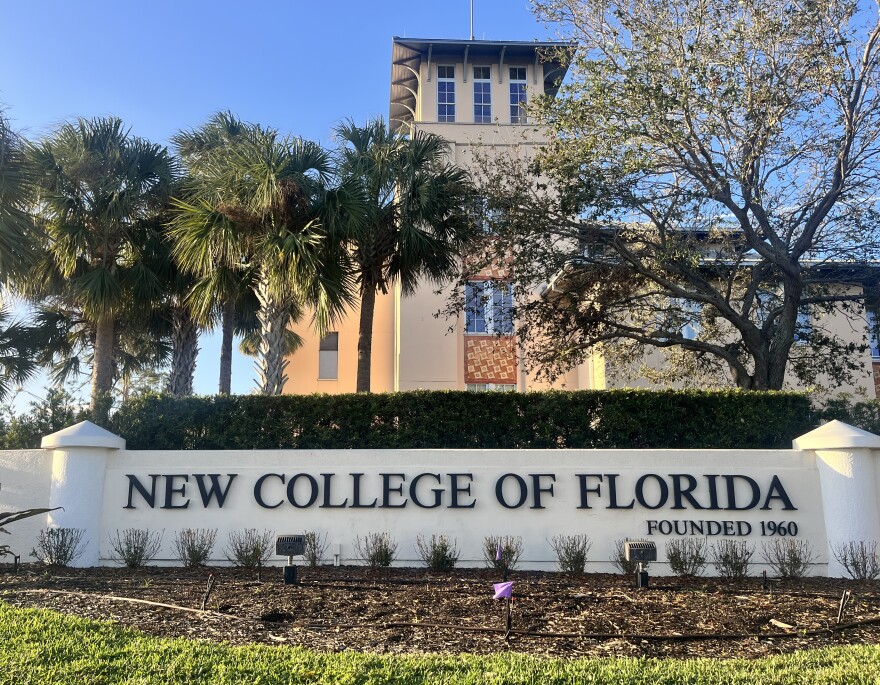 White exterior wall to the entrance says New College of Florida