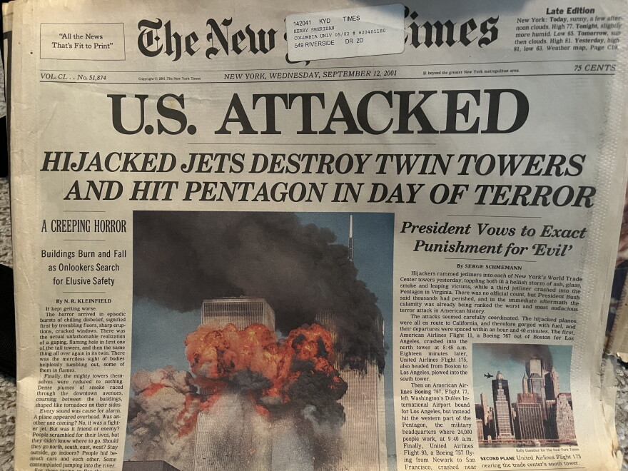 A newspaper front page from 9/12/01 that showed Twin Towers ablaze