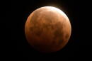 The total lunar eclipse is seen over Santa Monica Beach in Santa Monica, Calif., Wednesday, May 26, 2021. (Ringo H.W. Chiu/AP)