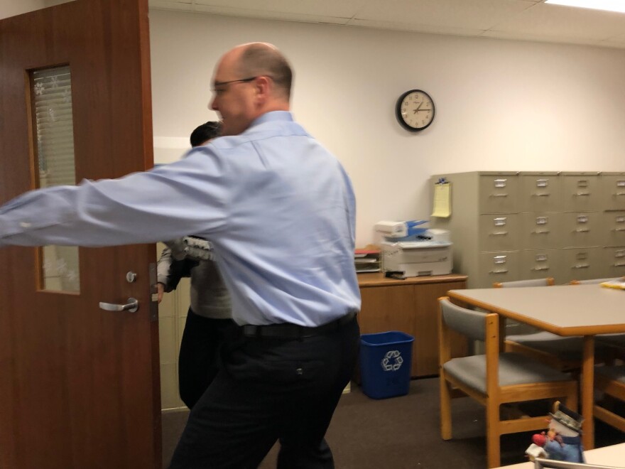 Michael Sotherland and Cheryl Racco close their office door when they hear gunfire during an active shooter simulation.