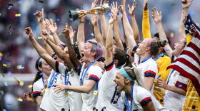 Megan Rapinoe of the USA lifts the FIFA Women's World Cup Trophy following her team's victory in the 2019 FIFA Women's World Cup France Final match between The United States of America and The Netherlands at Stade de Lyon in Lyon, France.