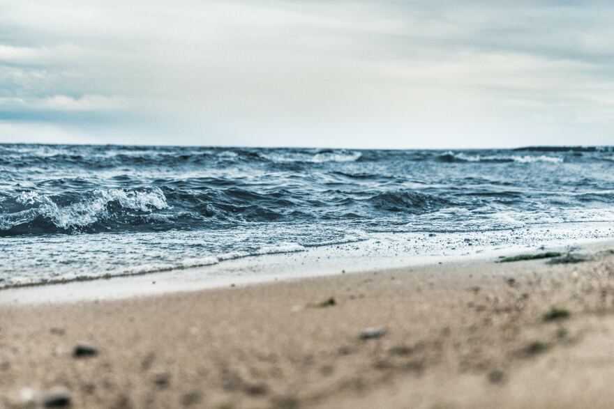 Water flows up onto a beach. 