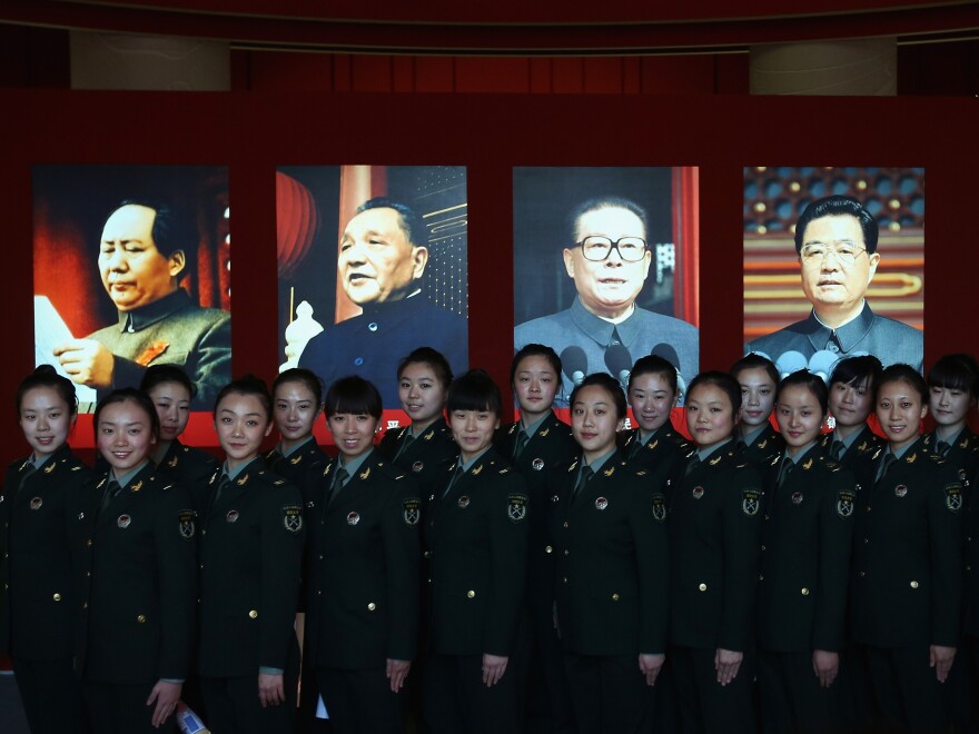 Soldiers pose in front of portraits of China's top Communist leaders (from left, Mao Zedong, Deng Xiaoping, Jiang Zemin and President Hu Jintao) at an exhibit before the 18th National Congress of the Communist Party of China, scheduled to begin Thursday in Beijing. China's next leader will be unveiled at the congress.
