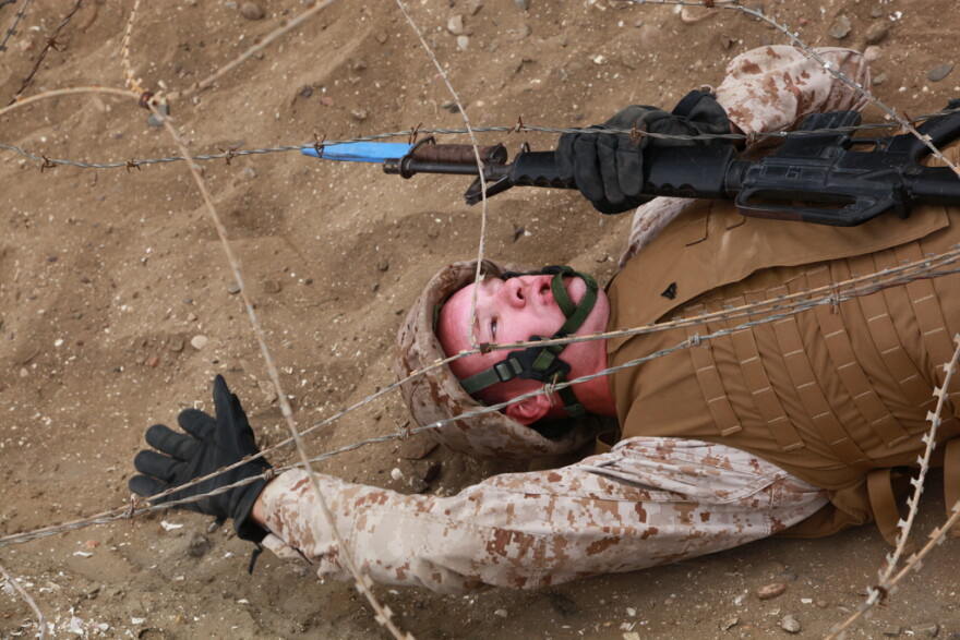 A U.S. Marine, with Headquarters and Headquarters Squadron, navigates under constantina wire during a bayonet course training evolution aboard Marine Corps Recruit Depot, San Diego, Calif., June 1, 2012.
