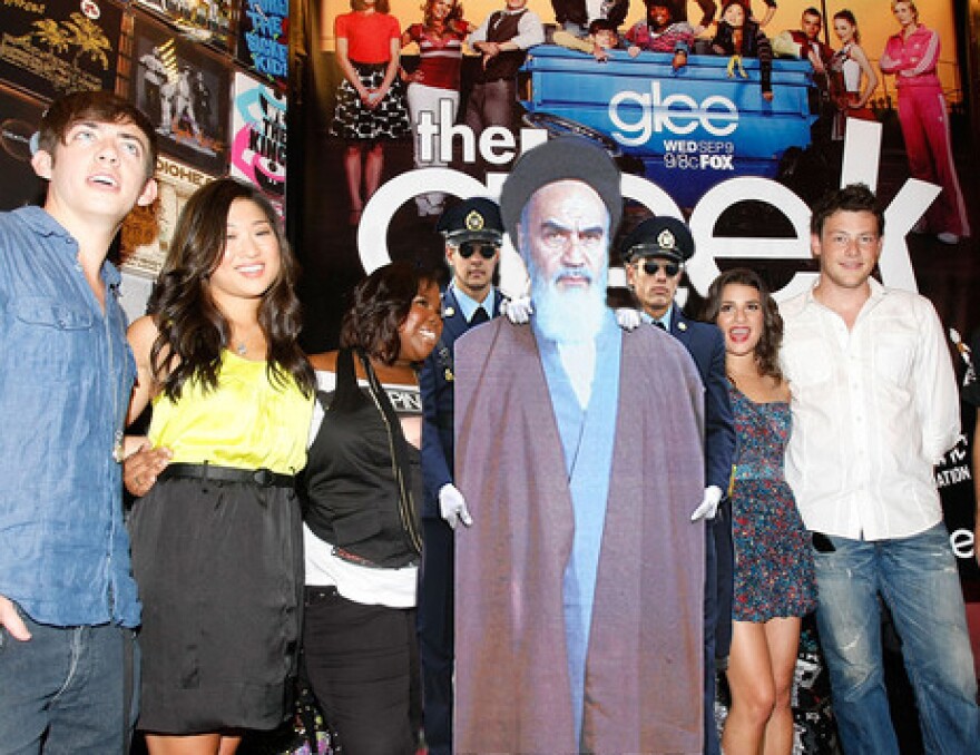 A cardboard cutout of the late Ayatollah Khomeini apparently schmoozing with the cast of Glee.