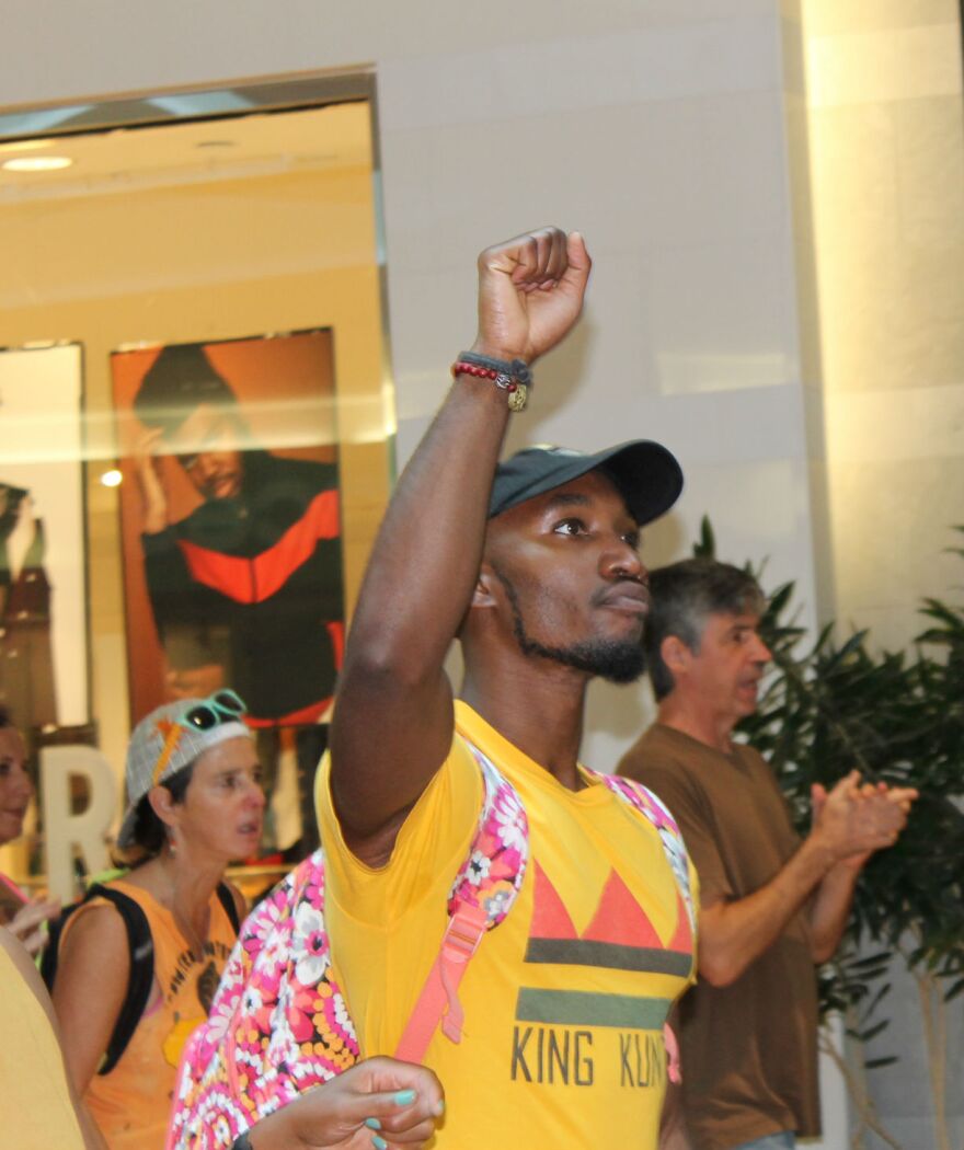 A protester at West County Center mall in Des Peres