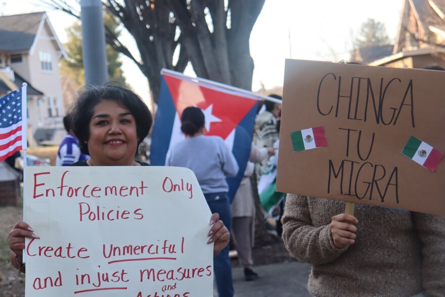 Louisville resident Martha Sanchez (left) holding a sign at a immigration rights rally