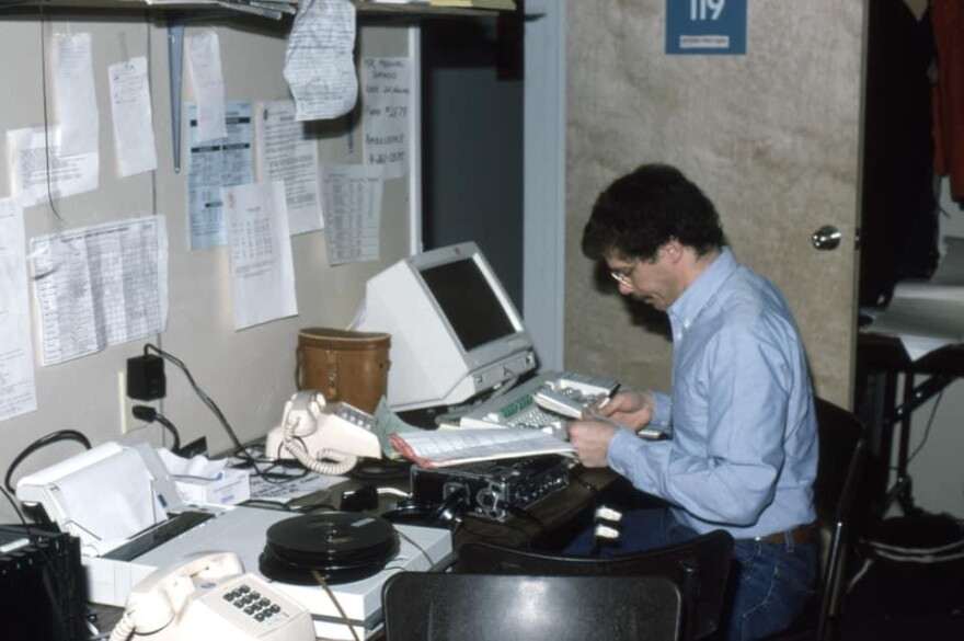 Man reviewing notes in home office. 