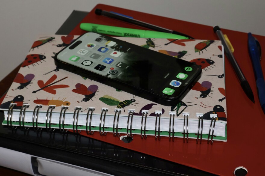 A cellphone and notebooks.