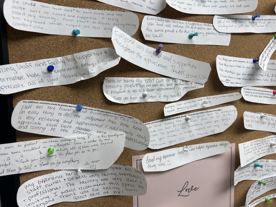 A cork board full of notes.