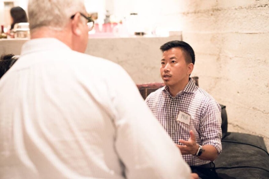 Min Matson, a transgender, liberal, Korean adoptee talks with Walt Shjeflo, a conservative who voted for President Trump, at Make America Dinner Again. (Maykel Loomans)