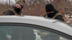 FILE - Immigration and Customs Enforcement (ICE) agents work during a traffic stop, Sunday, Jan. 11, 2026, in Robbinsdale, Minn.