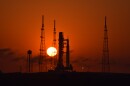 Sun rises behind the SLS rocket and Orion spacecraft.