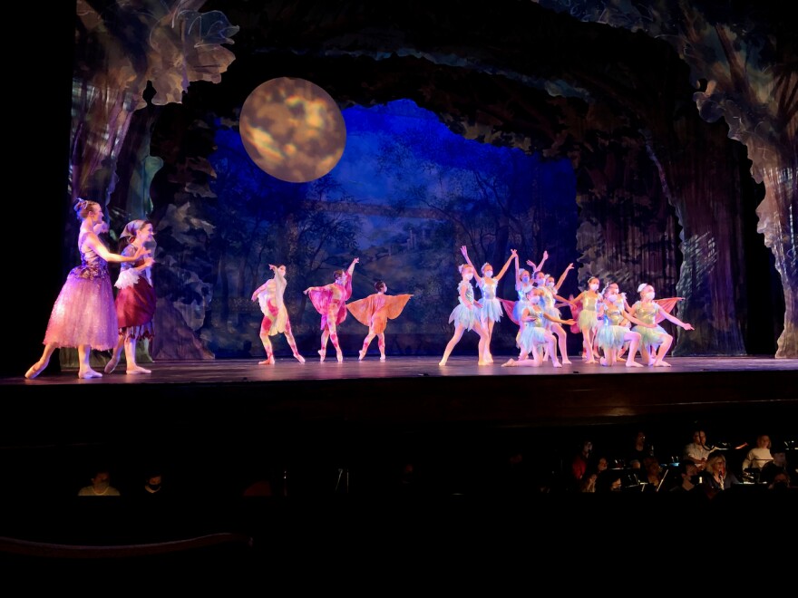 Cinderella, with her fairy godmother, left, watches as dragonflies and pixies perform