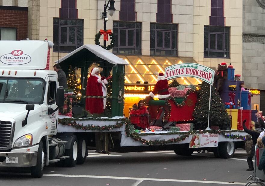 Santa, Mrs. Claus and elves from the North Pole wave to spectators as they pass the Kirby Center in the Wilkes-Barre Christmas Parade.
