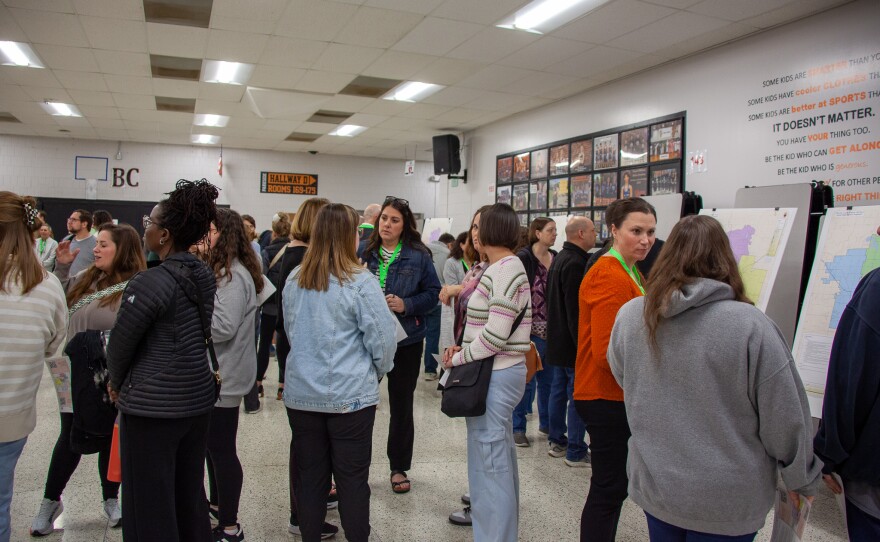 A large crowd holds seperate conversations.