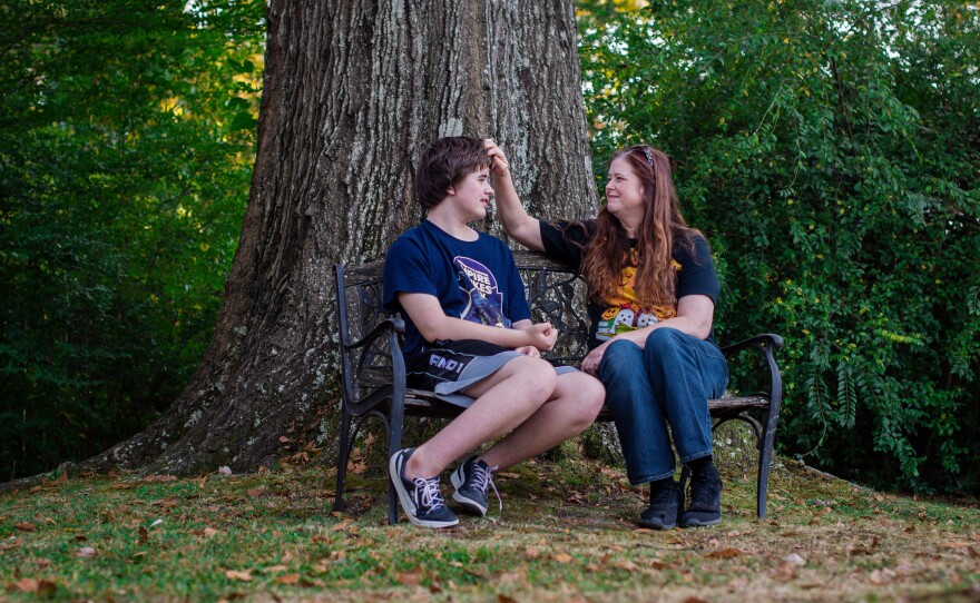 Ellen Griffin sits with her oldest son outside her home.